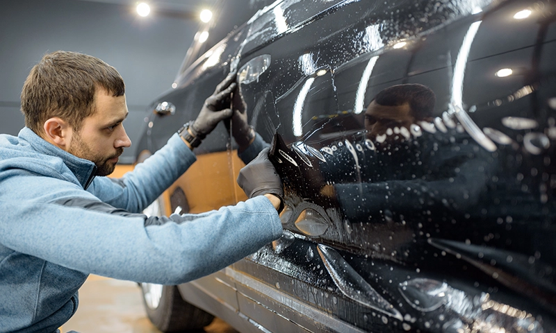 Ceramic Coating An expert applies ceramic coating to a door panel