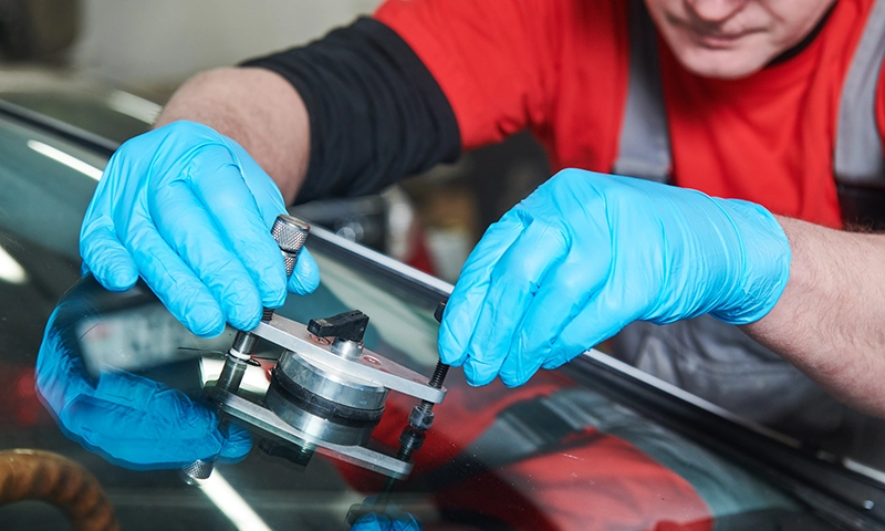 WindshieldShopRepair Windshield repair in process with glass tools